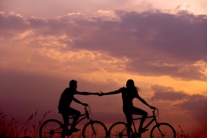 A couple holding hands at sunset